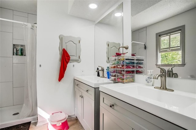 bathroom featuring a textured ceiling, hardwood / wood-style floors, vanity, and a shower with curtain