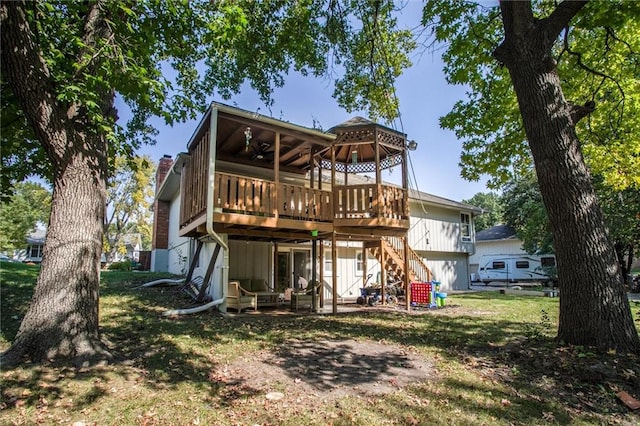 back of property featuring a yard and a wooden deck