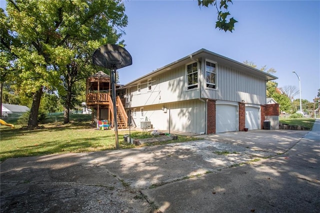 view of property exterior featuring a garage and a lawn