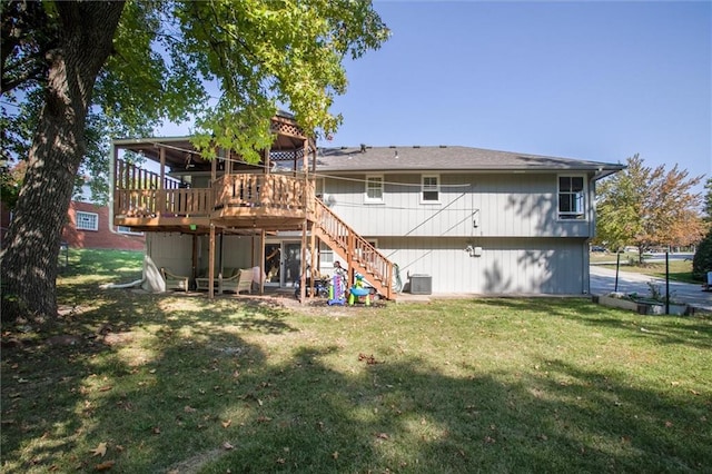 back of house featuring a yard, a wooden deck, and central AC