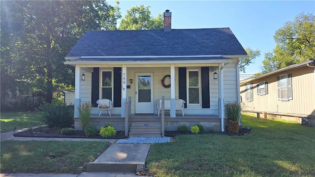 bungalow-style house featuring a porch and a front yard