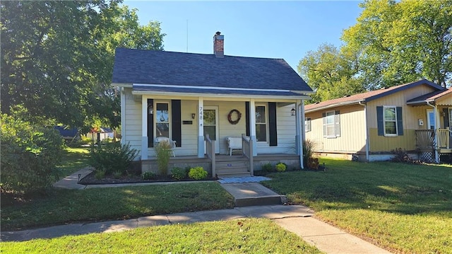 bungalow-style home featuring a front lawn and covered porch