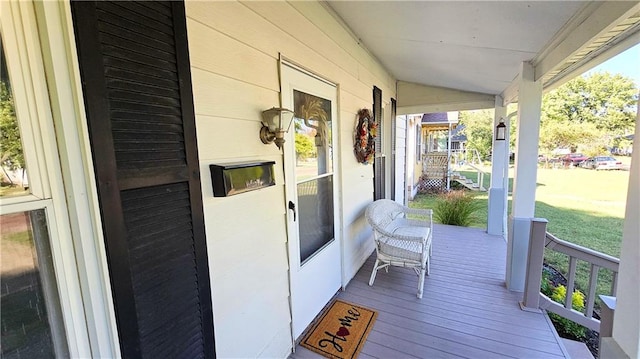 wooden terrace featuring a porch