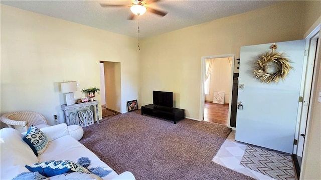 carpeted living room featuring ceiling fan