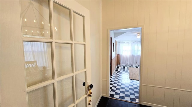 hallway with wood walls