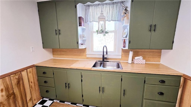 kitchen with green cabinetry and sink