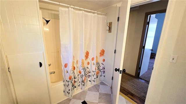 bathroom with shower / bath combo with shower curtain