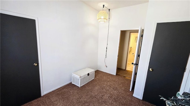 unfurnished room featuring dark carpet