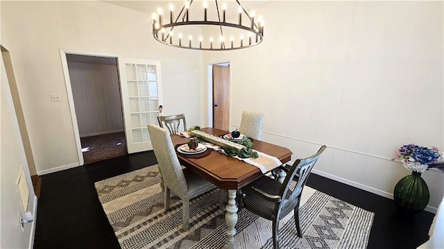 dining area featuring an inviting chandelier and hardwood / wood-style floors