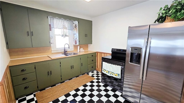 kitchen featuring black / electric stove, green cabinets, stainless steel fridge with ice dispenser, and sink