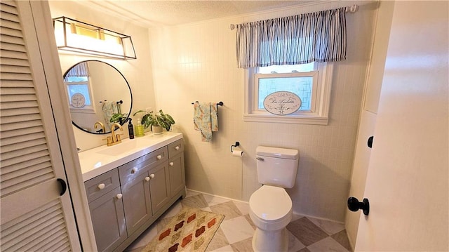 bathroom featuring vanity, tile walls, toilet, and a textured ceiling