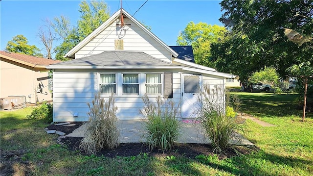 view of side of home featuring a yard