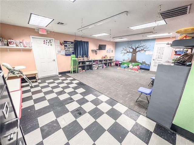 1201 S Willow St, Coffeyville, KS 67337 - misc room with tile patterned floors and a textured ceiling