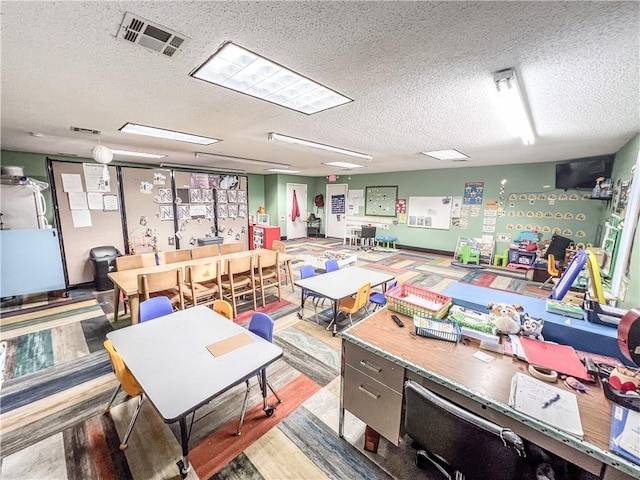 interior space featuring a textured ceiling and light hardwood / wood-style flooring