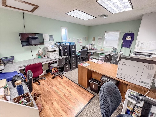 office featuring a textured ceiling and hardwood / wood-style flooring