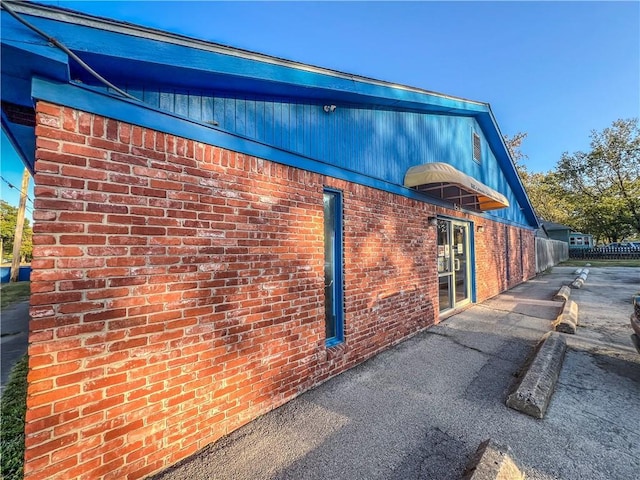1201 S Willow St, Coffeyville, KS 67337 - view of home's exterior featuring brick siding