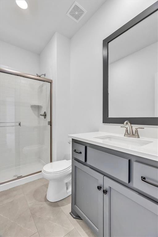 bathroom featuring visible vents, a shower stall, toilet, and vanity