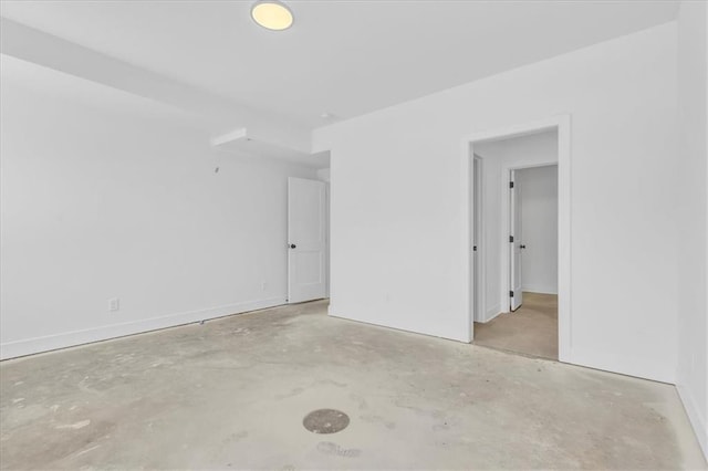 spare room with unfinished concrete floors