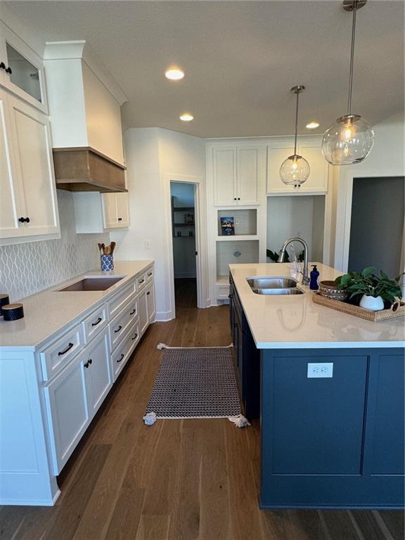 kitchen with dark wood-style flooring, white cabinets, black electric stovetop, and a sink