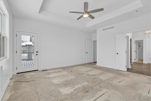 interior space with a raised ceiling, baseboards, visible vents, and ceiling fan