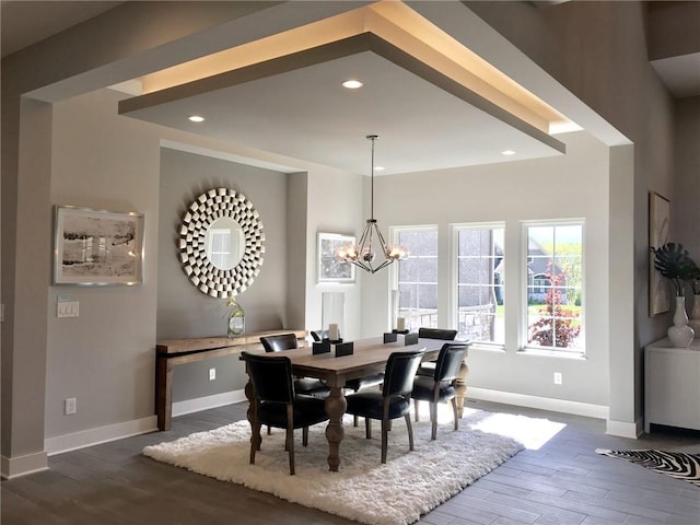 dining space featuring hardwood / wood-style flooring and an inviting chandelier