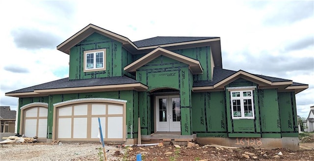 16928 Futura St, Overland Park, KS 66085 - property under construction featuring french doors, gravel driveway, a shingled roof, and a garage