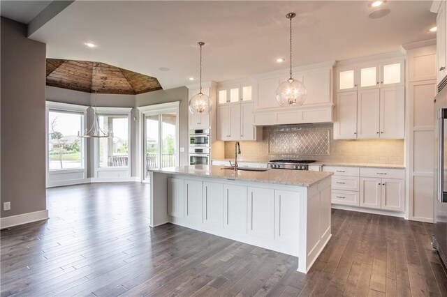 16928 Futura St, Overland Park, KS 66085 - kitchen featuring a sink, white cabinetry, lofted ceiling, dark wood-style flooring, and tasteful backsplash