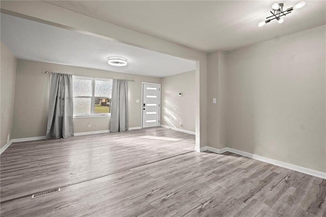 spare room with hardwood / wood-style flooring