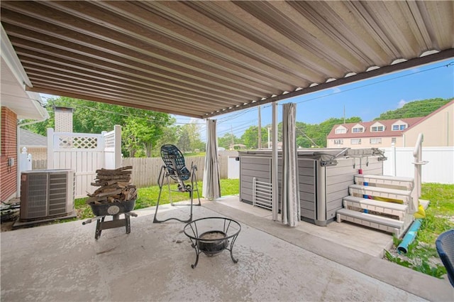 view of patio / terrace with a fire pit and cooling unit