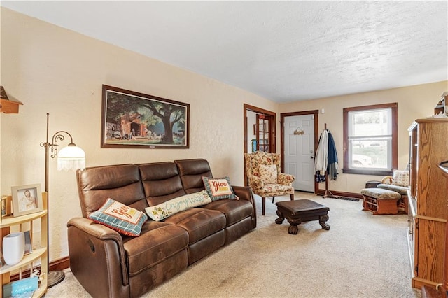 carpeted living room with a textured ceiling