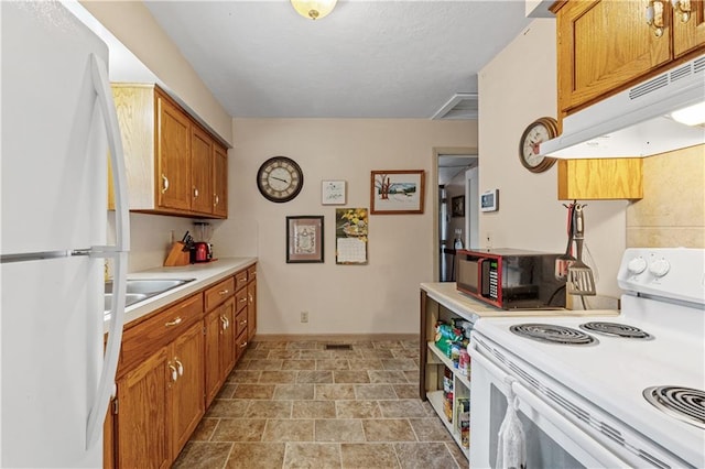 kitchen featuring sink and white appliances