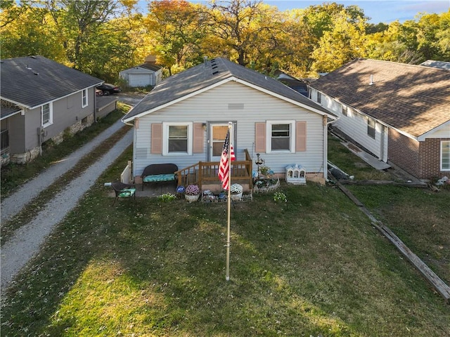 bungalow-style house featuring a front lawn