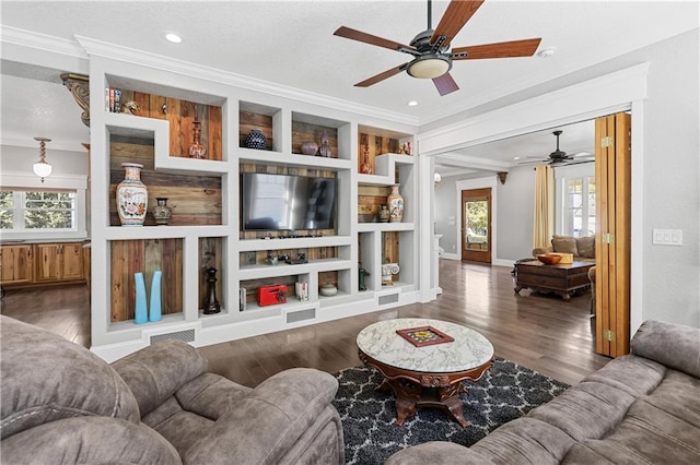 living room featuring ceiling fan, plenty of natural light, and dark hardwood / wood-style flooring