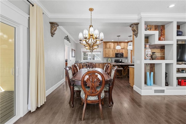 dining space featuring dark wood-type flooring, crown molding, and an inviting chandelier