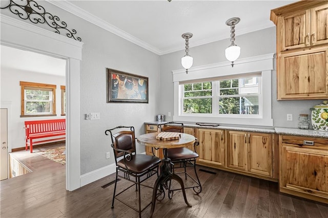 dining room with dark hardwood / wood-style floors and ornamental molding