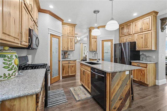 kitchen featuring pendant lighting, a center island with sink, black appliances, and dark hardwood / wood-style flooring