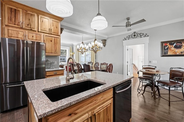 kitchen featuring ornamental molding, sink, a kitchen island, dark wood-type flooring, and stainless steel appliances