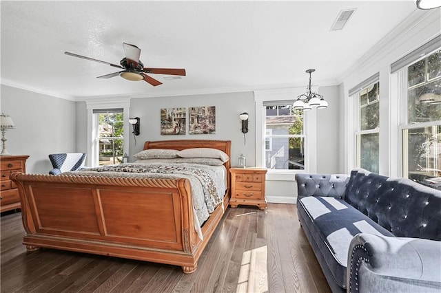 bedroom with ceiling fan with notable chandelier, ornamental molding, and dark hardwood / wood-style flooring