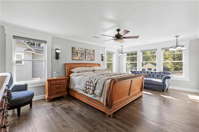 bedroom with ceiling fan with notable chandelier, crown molding, and dark wood-type flooring