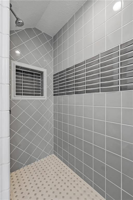 bathroom with tiled shower