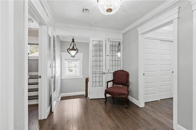 sitting room featuring ornamental molding, a notable chandelier, a textured ceiling, and dark hardwood / wood-style flooring