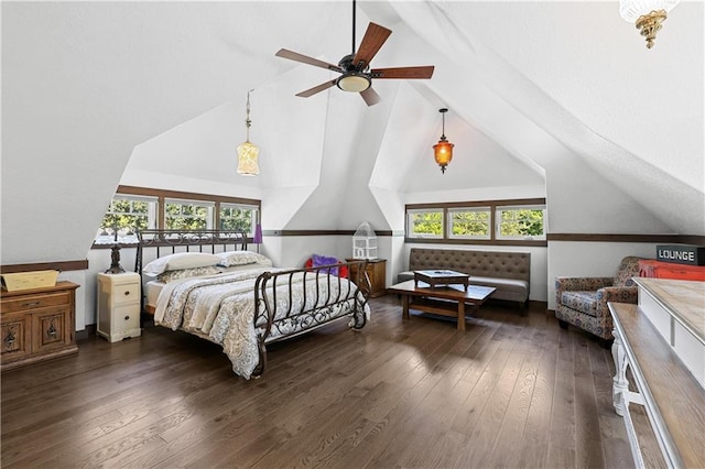 bedroom with vaulted ceiling, dark wood-type flooring, and multiple windows