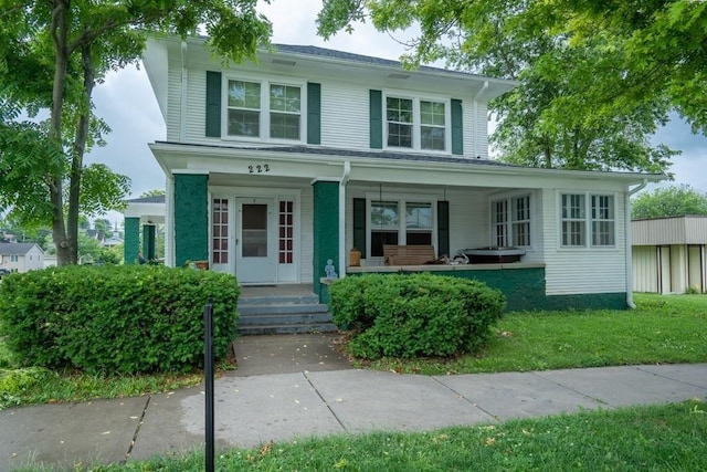 view of front of home featuring a front lawn and a porch