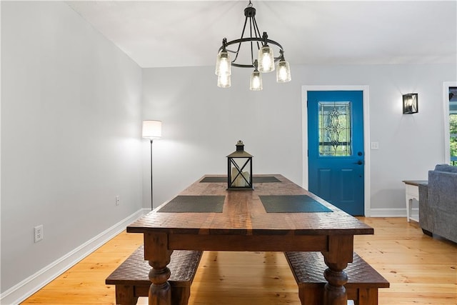 dining area with a chandelier and light hardwood / wood-style flooring