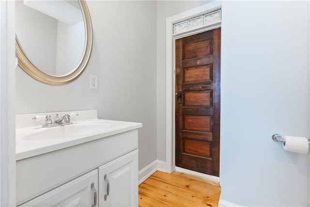 bathroom with vanity and wood-type flooring