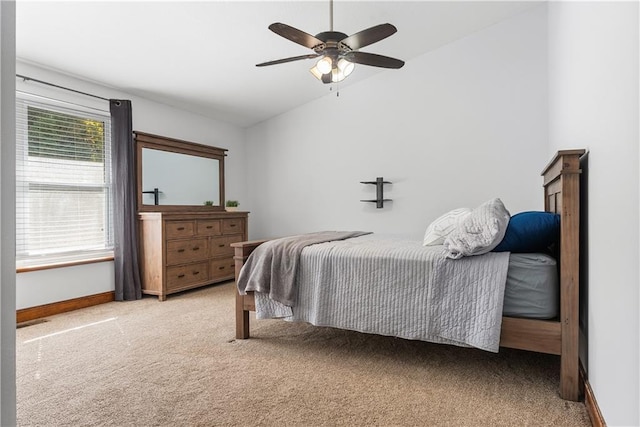 bedroom featuring vaulted ceiling, light carpet, and ceiling fan