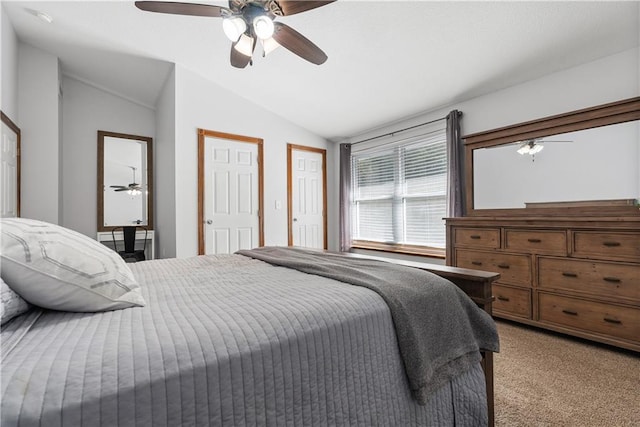 carpeted bedroom with ceiling fan and lofted ceiling