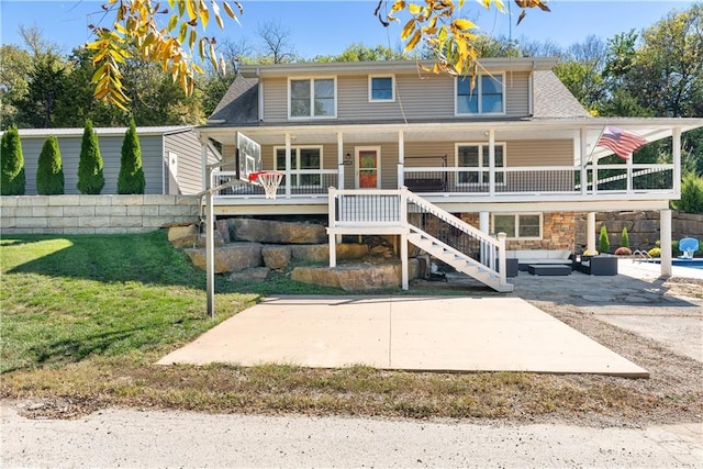 view of front of property featuring stairs, a patio, a porch, and a front yard