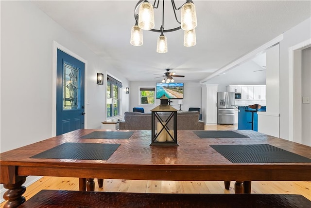 dining area with ceiling fan with notable chandelier