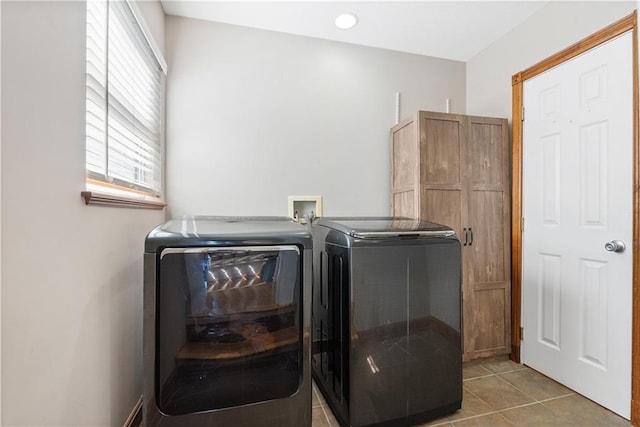 laundry area with light tile patterned floors, separate washer and dryer, and laundry area